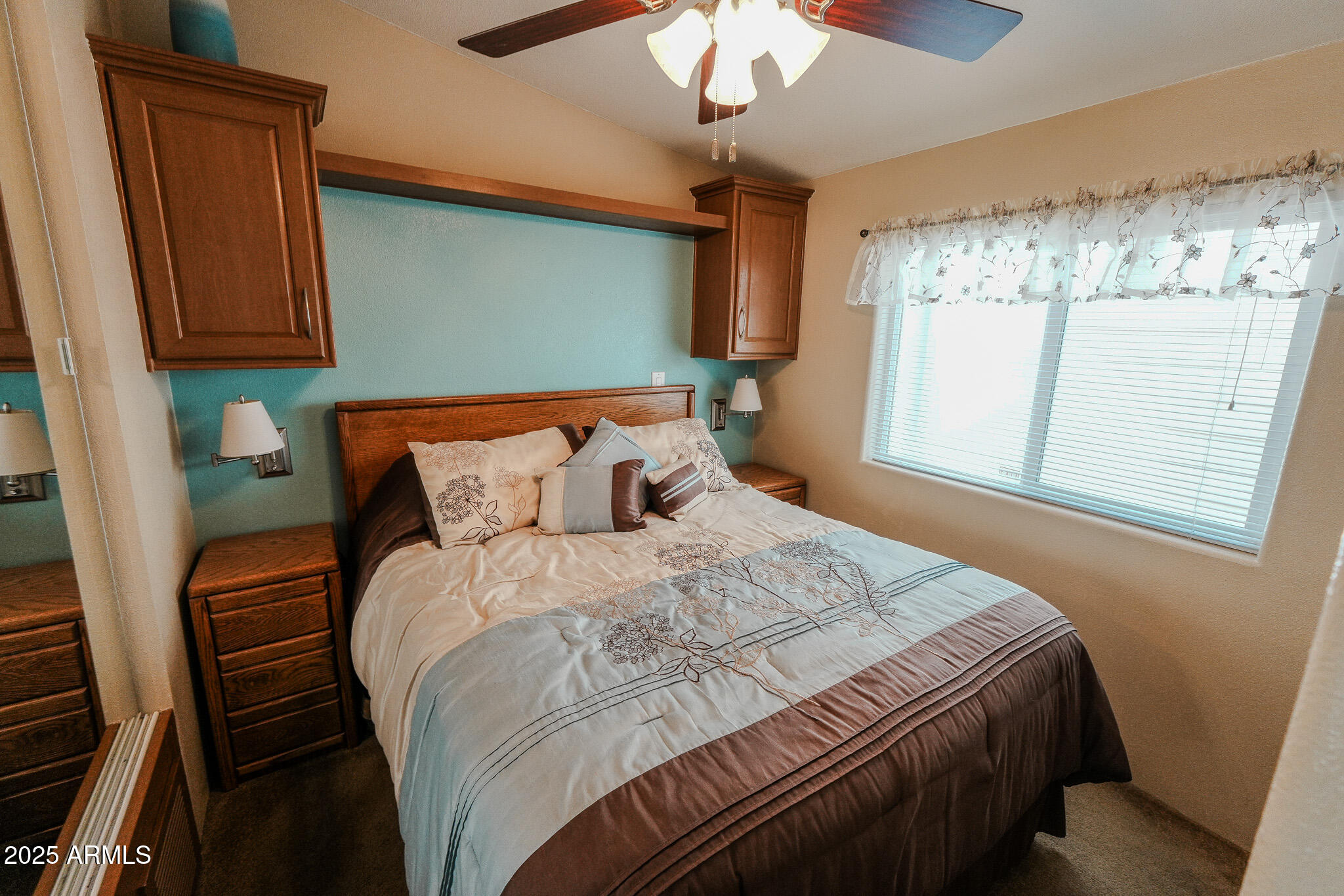 17200 West Bell Road, Unit 915 Surprise, AZ 85374 - Photo 4 of 32 a bedroom with a bed and a chandelier