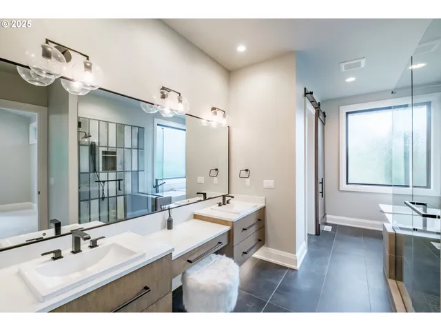 a bathroom with a sink mirror and a bathtub