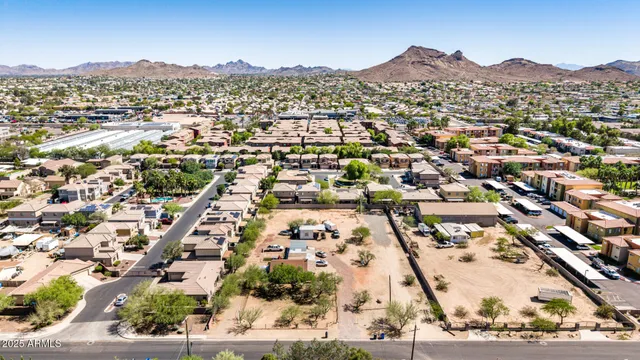 an aerial view of residential houses with city view