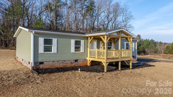 a front view of a house with a yard table and chairs