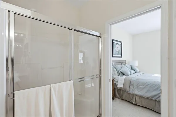 a bathroom with a toilet a sink a mirror a shower and vanity