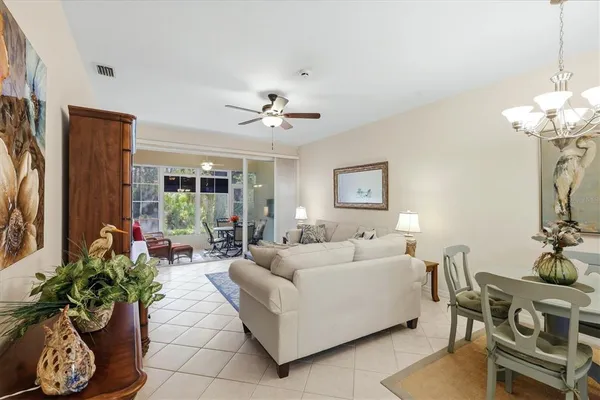 a living room with furniture a ceiling fan and a rug