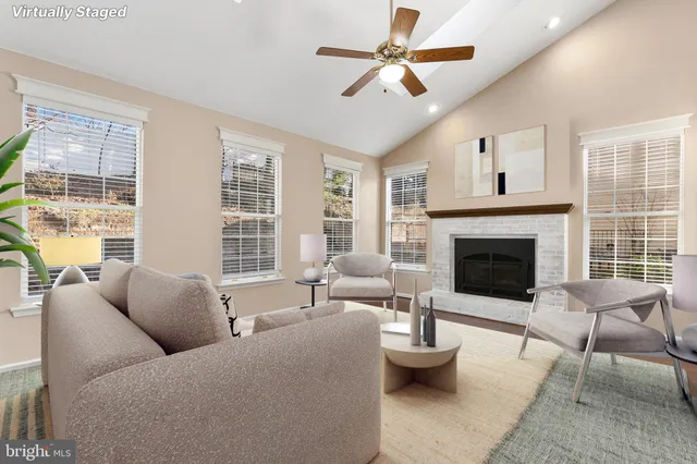 a view of a room with wooden floor and a ceiling fan