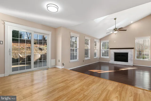 a kitchen with granite countertop stainless steel appliances a sink and refrigerator