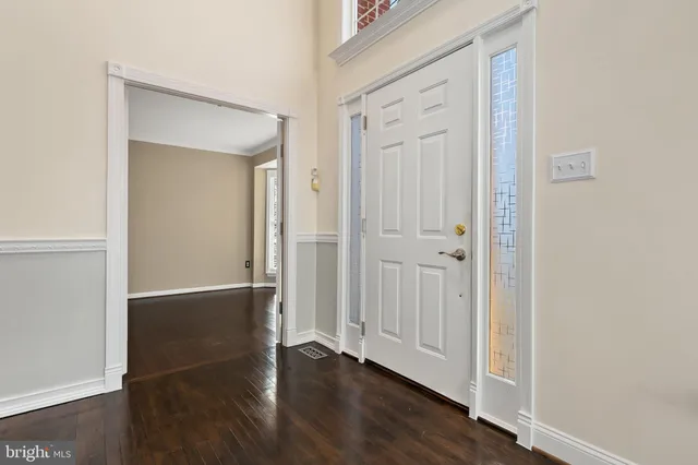 an empty room with wooden floor & closet area