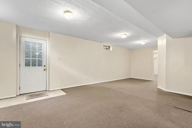 a view of a house with a yard and furniture