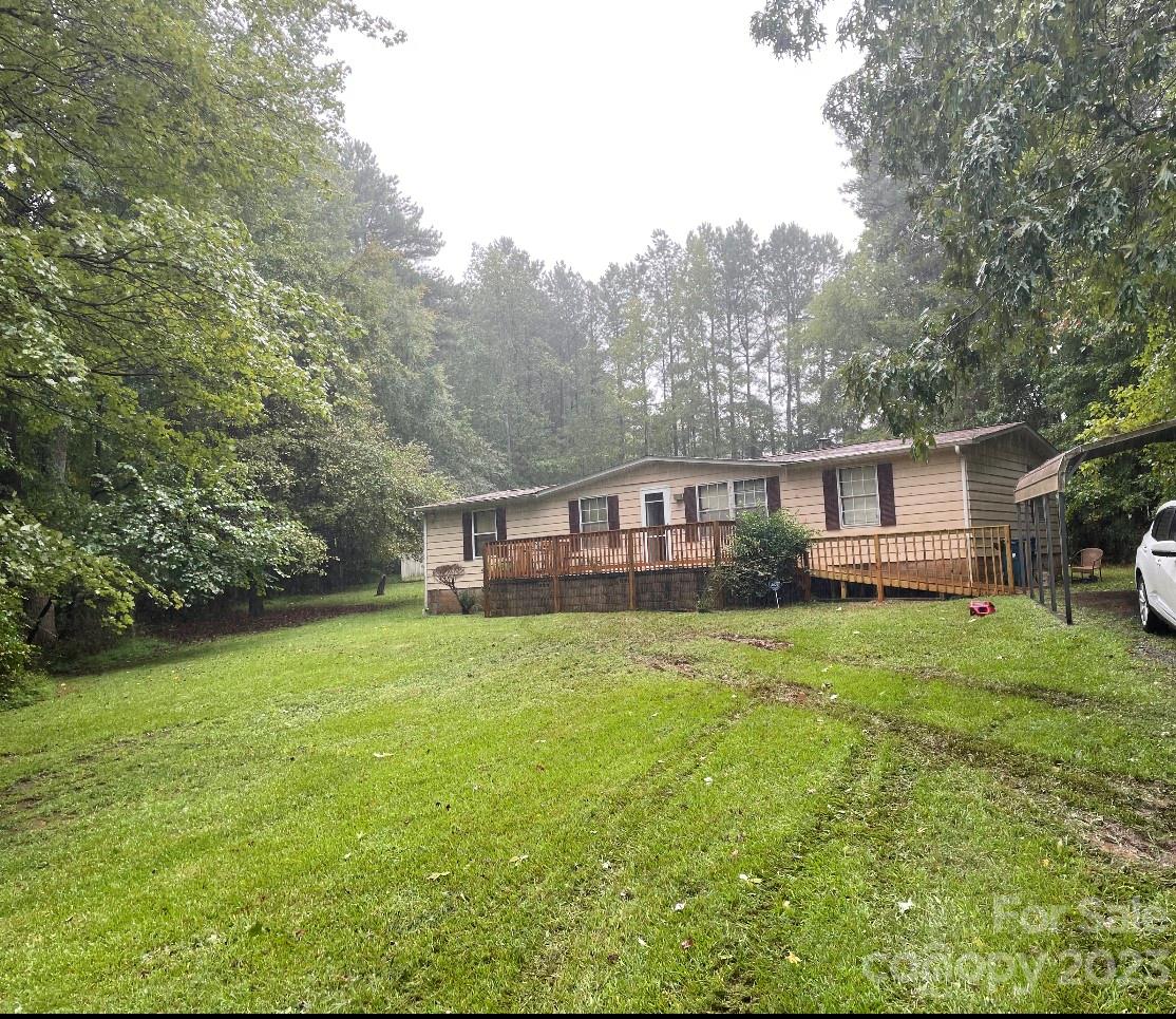 2121 Milton Road Durham, NC 27712 - Photo 1 of 14 a front view of a house with a garden