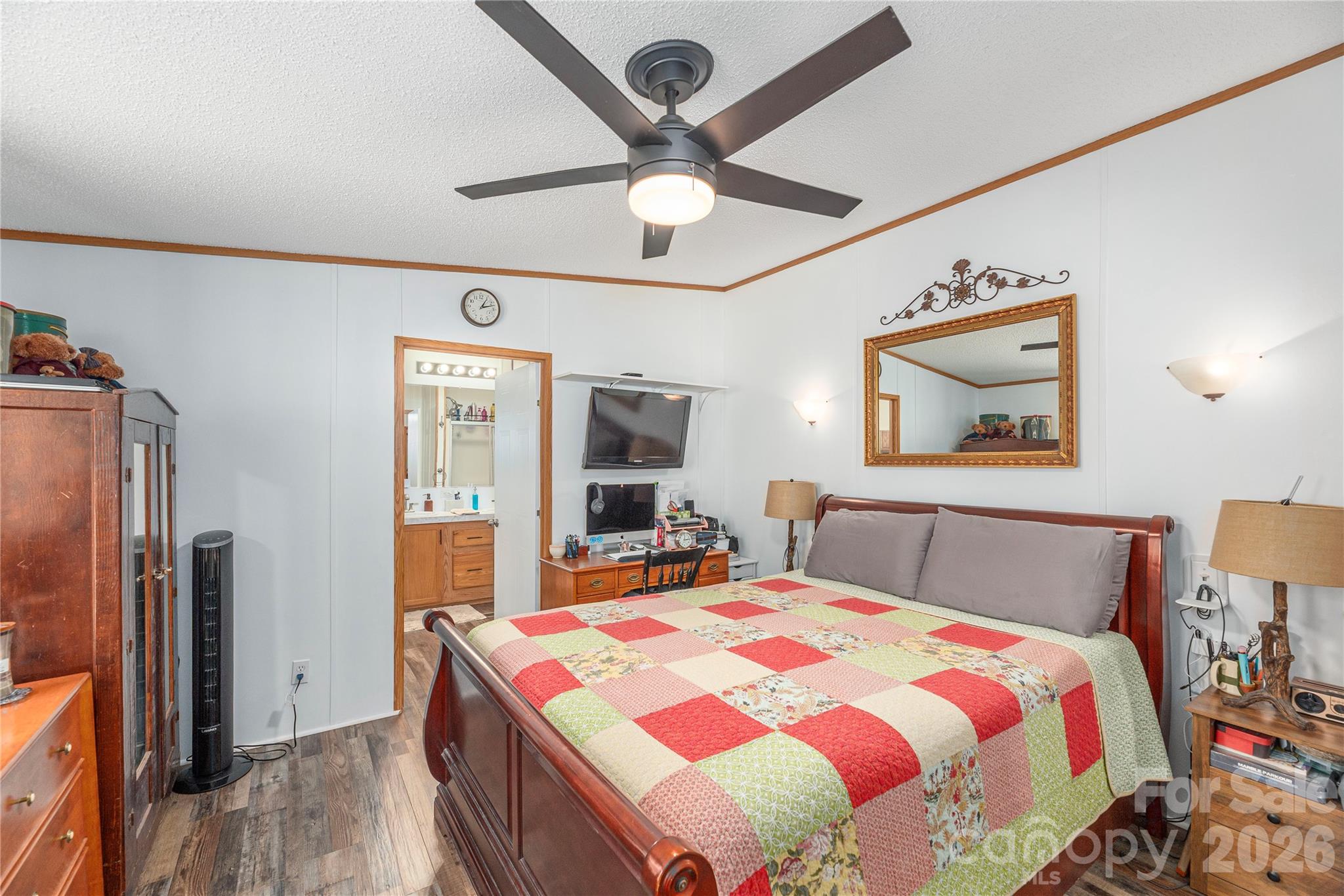 40 Farmstead Road Leicester, NC 28748 - Photo 13 of 29 a bedroom with a bed and a large mirror with a flat tv screen