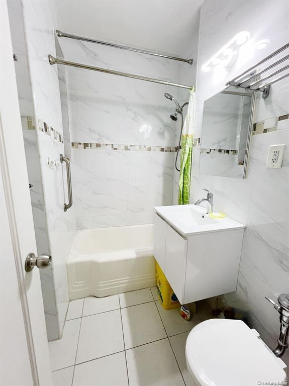 112-19 34th Avenue, Unit F Queens, NY 11368 - Photo 8 of 11 a bathroom with a sink a toilet and shower