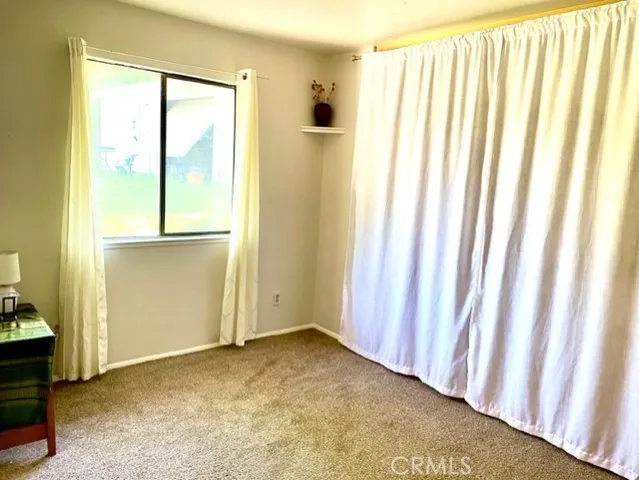 a view of empty room with wooden floor and windows