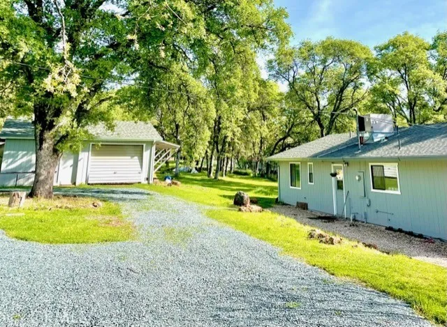 a view of a house with swimming pool and a yard