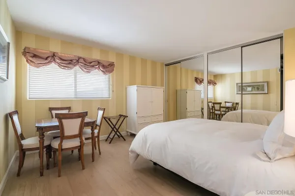 a bedroom with a bed a table and chair