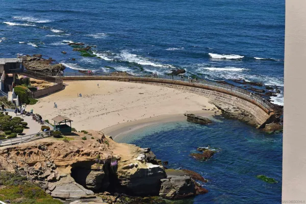 a view of a balcony with chairs and an umbrella