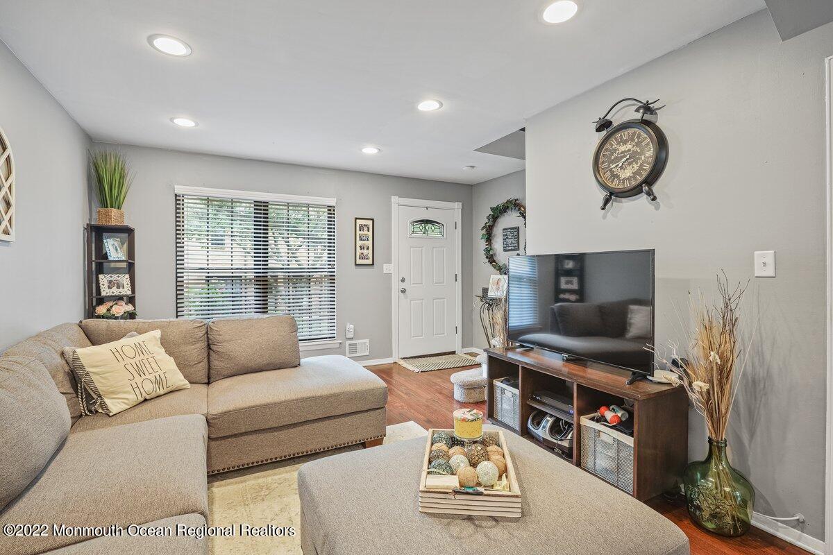 321 Spring Street, Unit 11 Red Bank, NJ 07701 - Photo 15 of 29 a living room with furniture and a flat screen tv