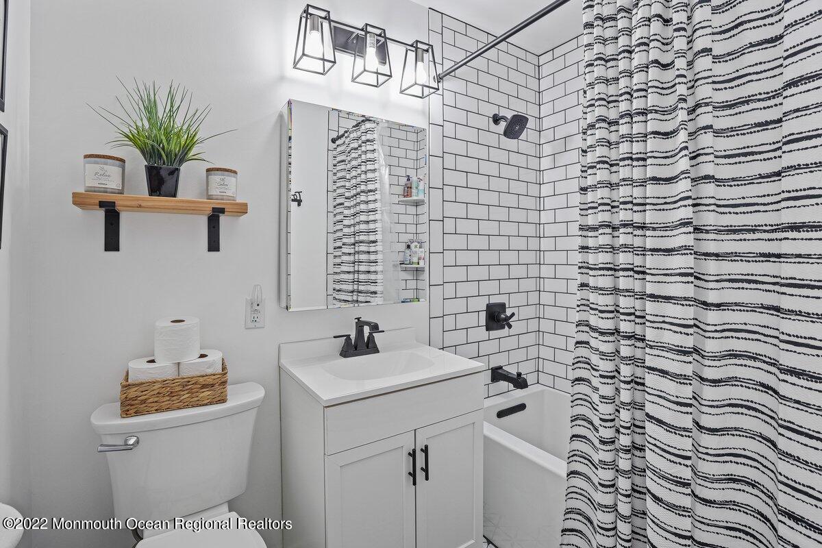 321 Spring Street, Unit 11 Red Bank, NJ 07701 - Photo 20 of 29 a bathroom with a sink a toilet and shower