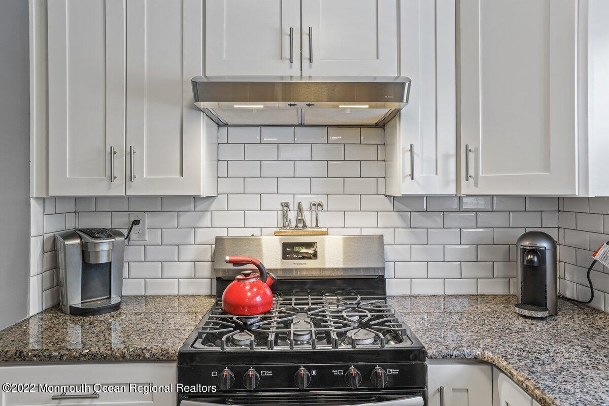 321 Spring Street, Unit 11 Red Bank, NJ 07701 - Photo 10 of 29 a kitchen with an stove and cabinets