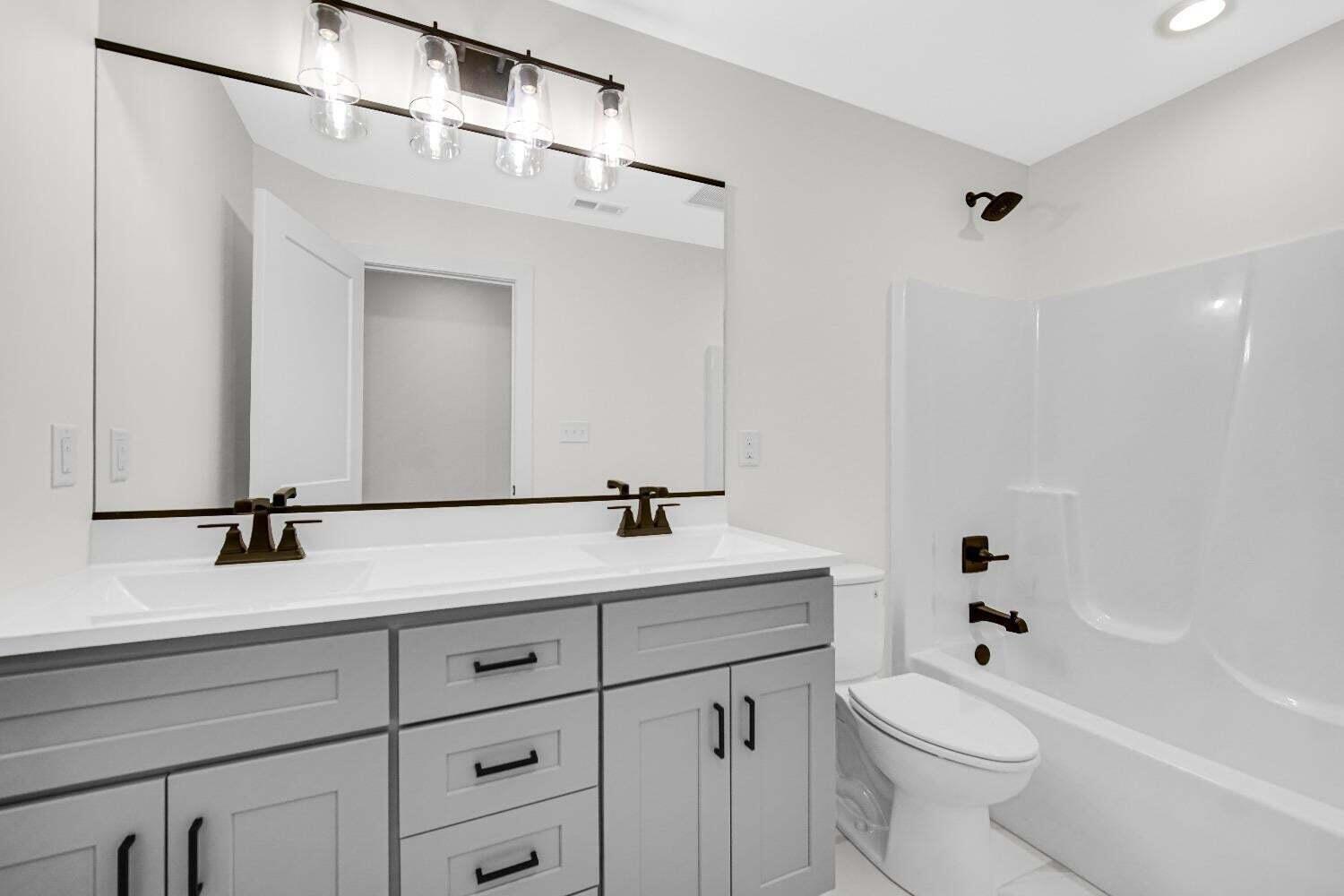 712 Verdano Terrace Crown Point, IN 46307 - Photo 18 of 24 a bathroom with a sink a toilet and a mirror