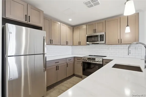 a kitchen with a refrigerator sink and microwave