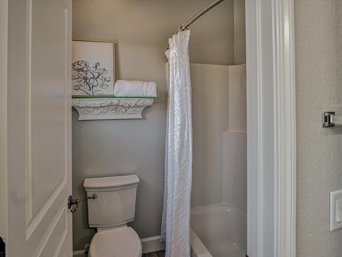 1042 Promenade Street Hercules, CA 94547 - Photo 24 of 60 a white toilet sitting next to a shower