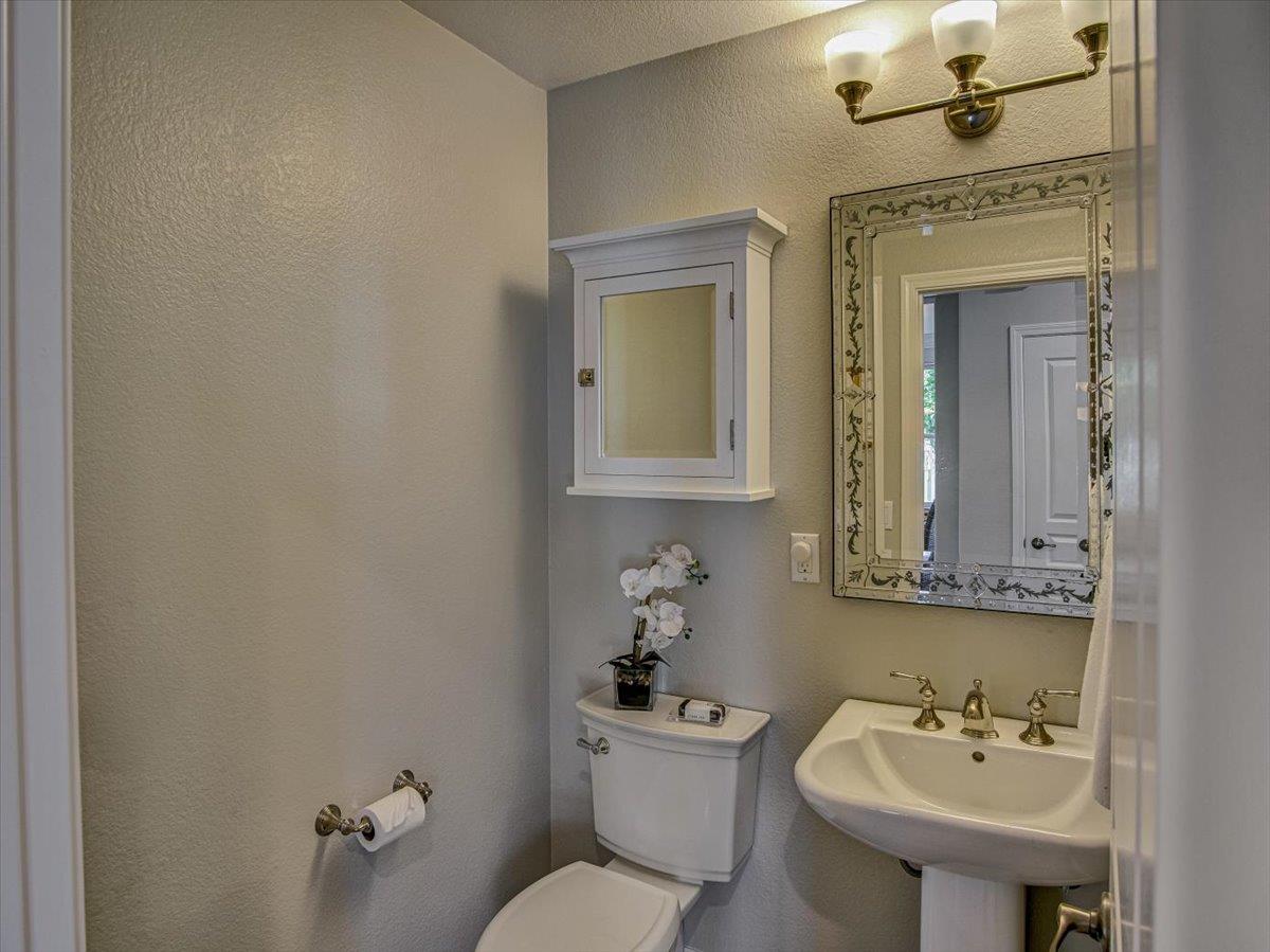 1042 Promenade Street Hercules, CA 94547 - Photo 30 of 60 a bathroom with a sink mirror and toilet