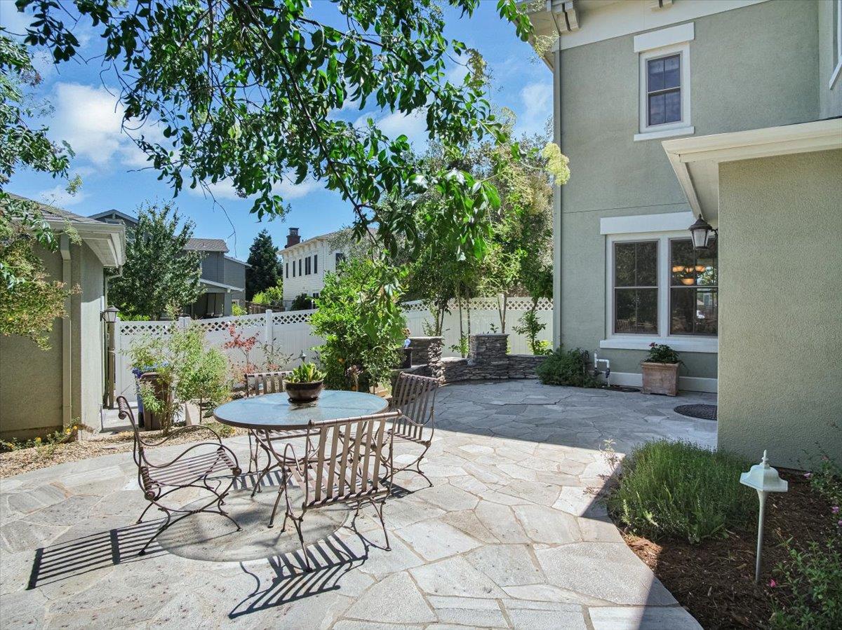 1042 Promenade Street Hercules, CA 94547 - Photo 40 of 60 a view of a patio with table and chairs potted plants and large tree