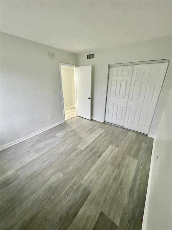 2252 Northwest 183rd Street, Unit 4 Miami Gardens, FL 33056 - Photo 7 of 15 wooden floor in an empty room