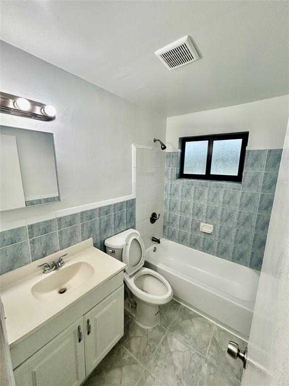 2252 Northwest 183rd Street, Unit 4 Miami Gardens, FL 33056 - Photo 10 of 15 a bathroom with a toilet a sink and bathtub