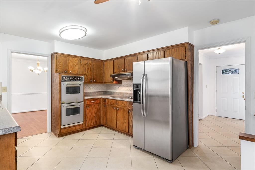2738 Rainbow Ridge Road Decatur, GA 30034 - Photo 12 of 47 a kitchen with stainless steel appliances granite countertop a refrigerator and a sink
