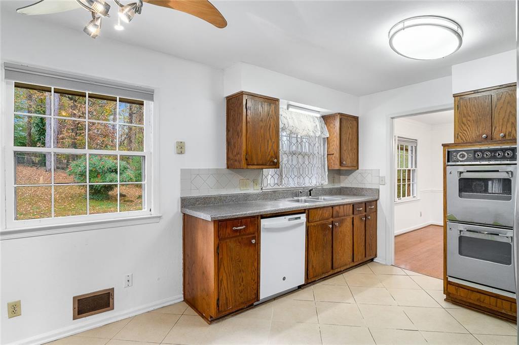 2738 Rainbow Ridge Road Decatur, GA 30034 - Photo 13 of 47 a kitchen with stainless steel appliances granite countertop a stove and a sink