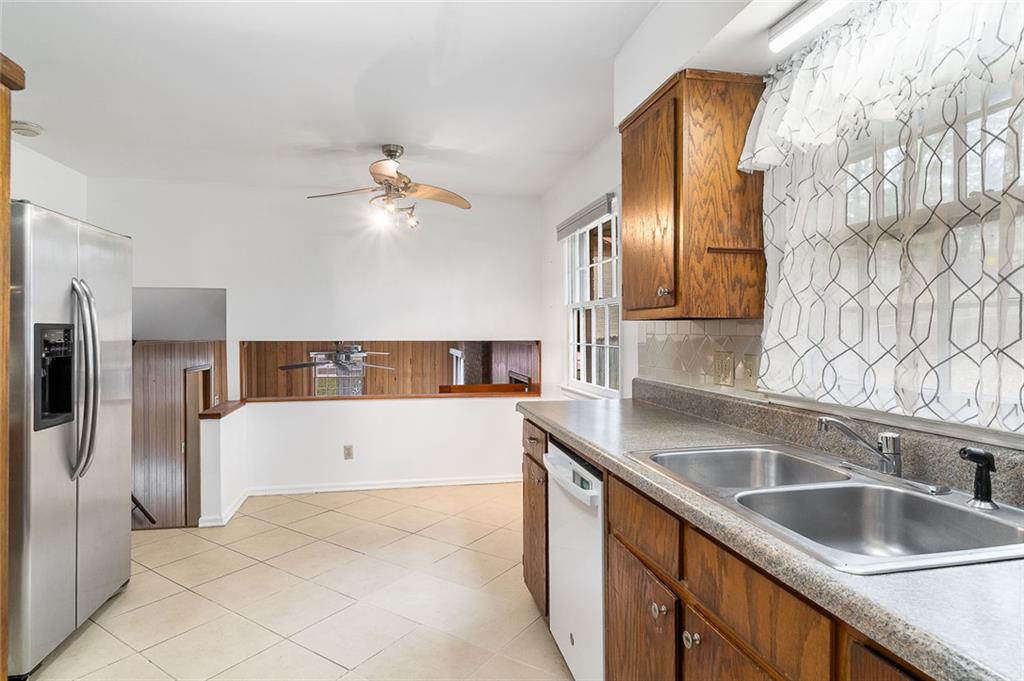 2738 Rainbow Ridge Road Decatur, GA 30034 - Photo 14 of 47 a kitchen with a sink and a refrigerator