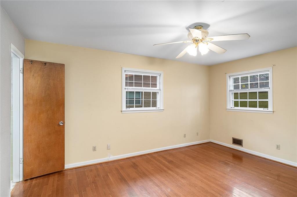 2738 Rainbow Ridge Road Decatur, GA 30034 - Photo 17 of 47 a view of an empty room with wooden floor and a window
