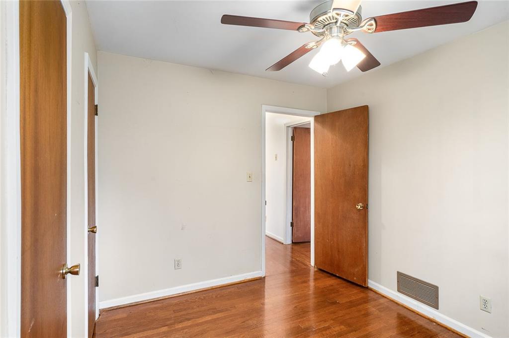 2738 Rainbow Ridge Road Decatur, GA 30034 - Photo 19 of 47 an empty room with wooden floor and door