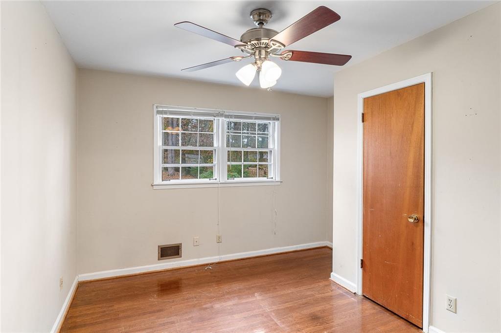 2738 Rainbow Ridge Road Decatur, GA 30034 - Photo 20 of 47 a view of an empty room with window and wooden floor