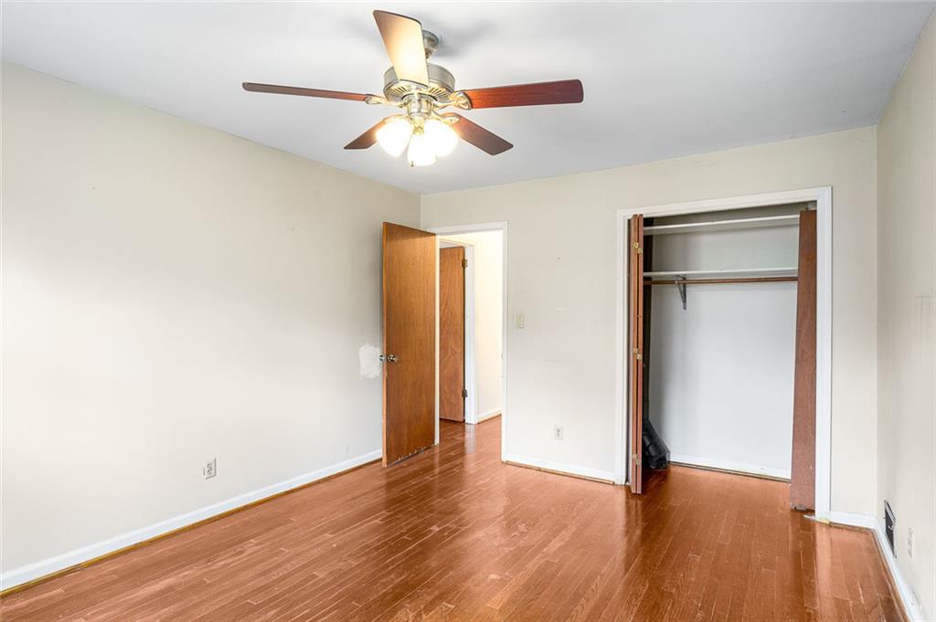 2738 Rainbow Ridge Road Decatur, GA 30034 - Photo 23 of 47 an empty room with wooden floor closet and windows