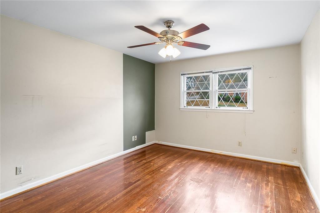2738 Rainbow Ridge Road Decatur, GA 30034 - Photo 24 of 47 a view of an empty room with wooden floor and a ceiling fan