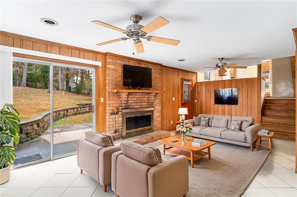 2738 Rainbow Ridge Road Decatur, GA 30034 - Photo 27 of 47 a living room with furniture a fireplace and a flat screen tv