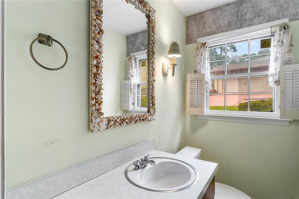 2738 Rainbow Ridge Road Decatur, GA 30034 - Photo 31 of 47 a bathroom with a toilet a sink and a mirror