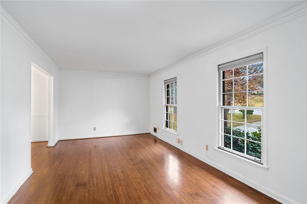 2738 Rainbow Ridge Road Decatur, GA 30034 - Photo 7 of 47 an empty room with wooden floor and windows