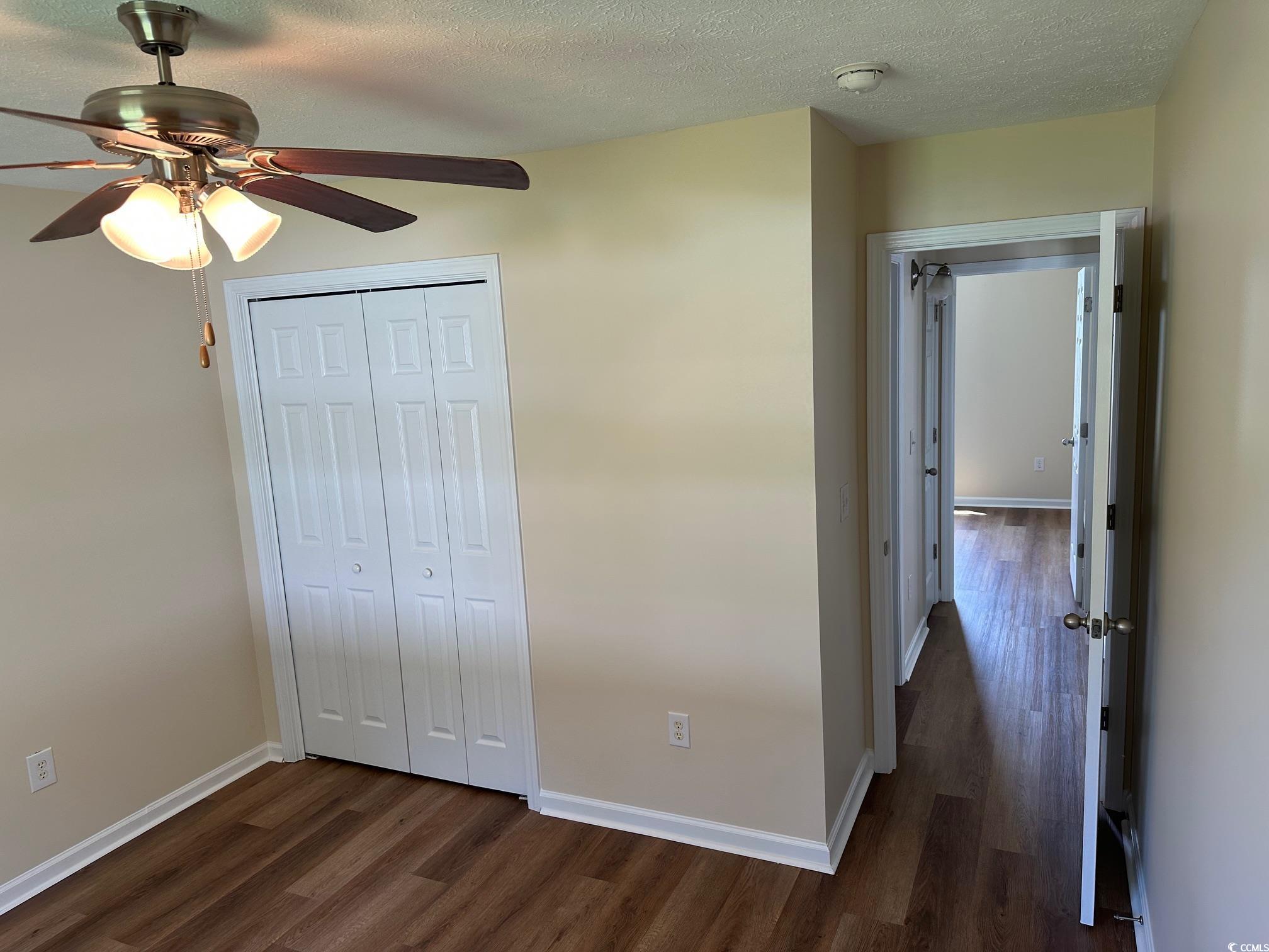 753 Bucklin Loop Myrtle Beach, SC 29579 - Photo 13 of 21 Unfurnished bedroom featuring dark wood finished f