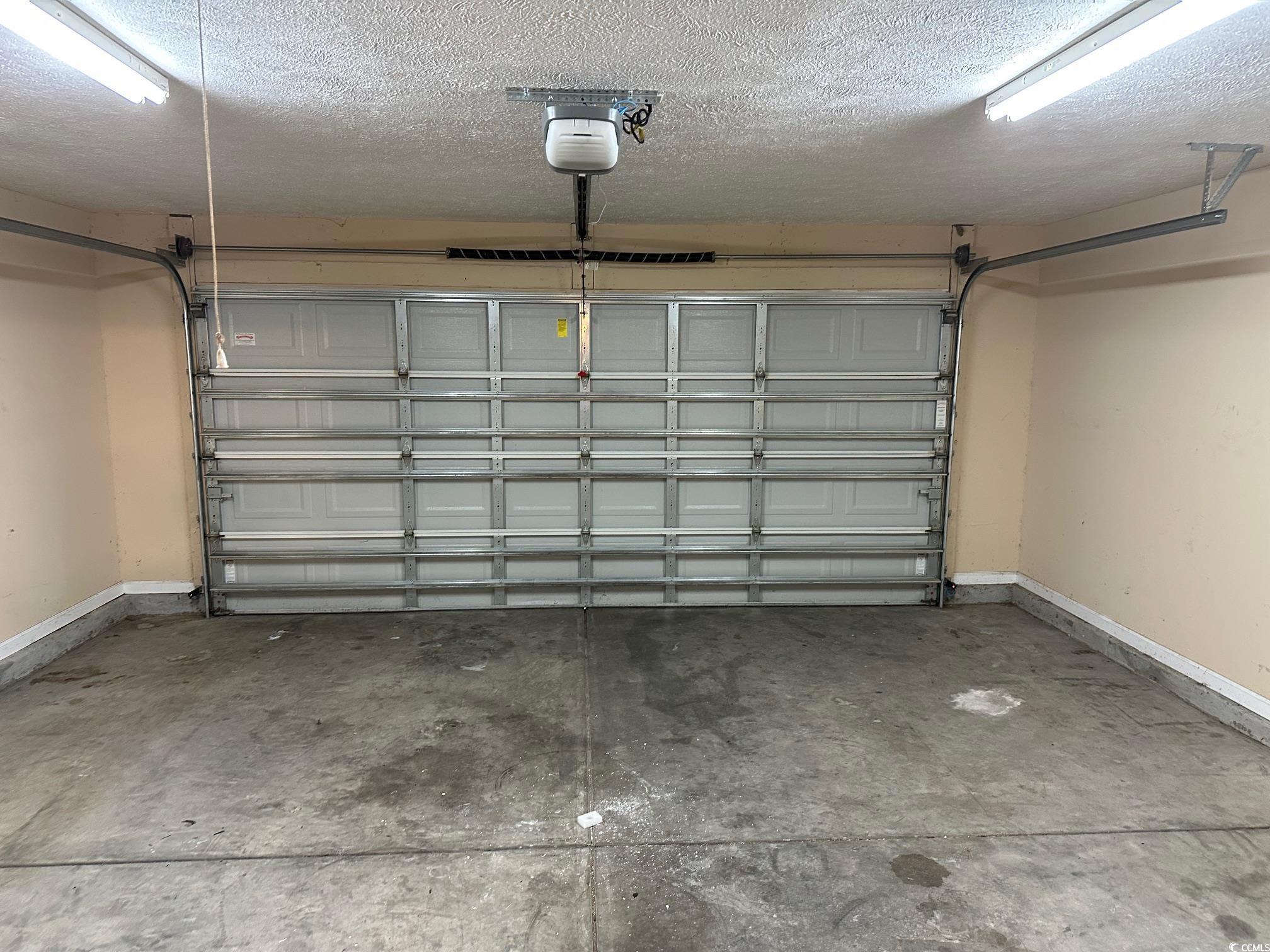 753 Bucklin Loop Myrtle Beach, SC 29579 - Photo 17 of 21 Garage featuring baseboards and a garage door open