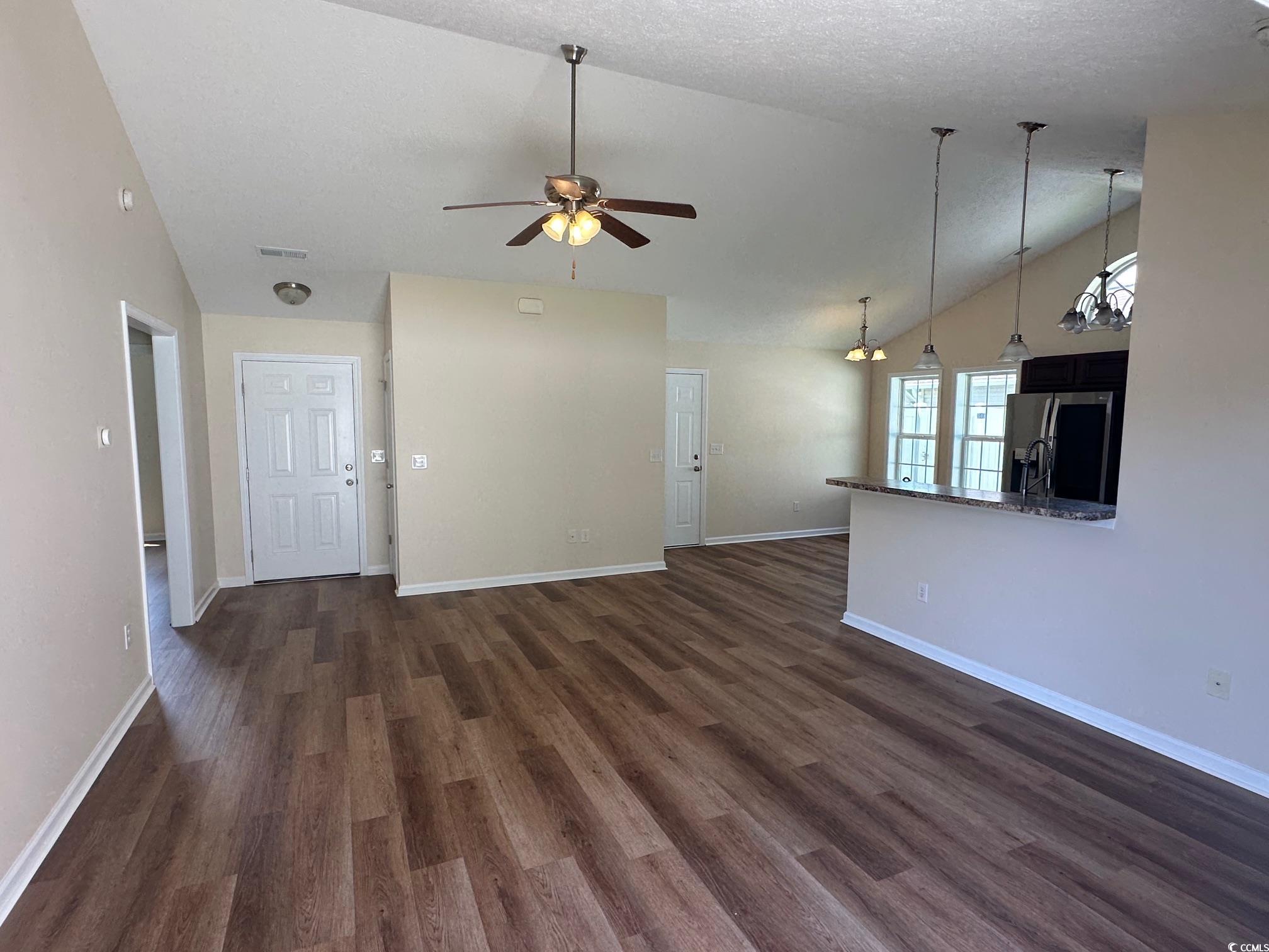 753 Bucklin Loop Myrtle Beach, SC 29579 - Photo 3 of 21 Unfurnished living room featuring vaulted ceiling,
