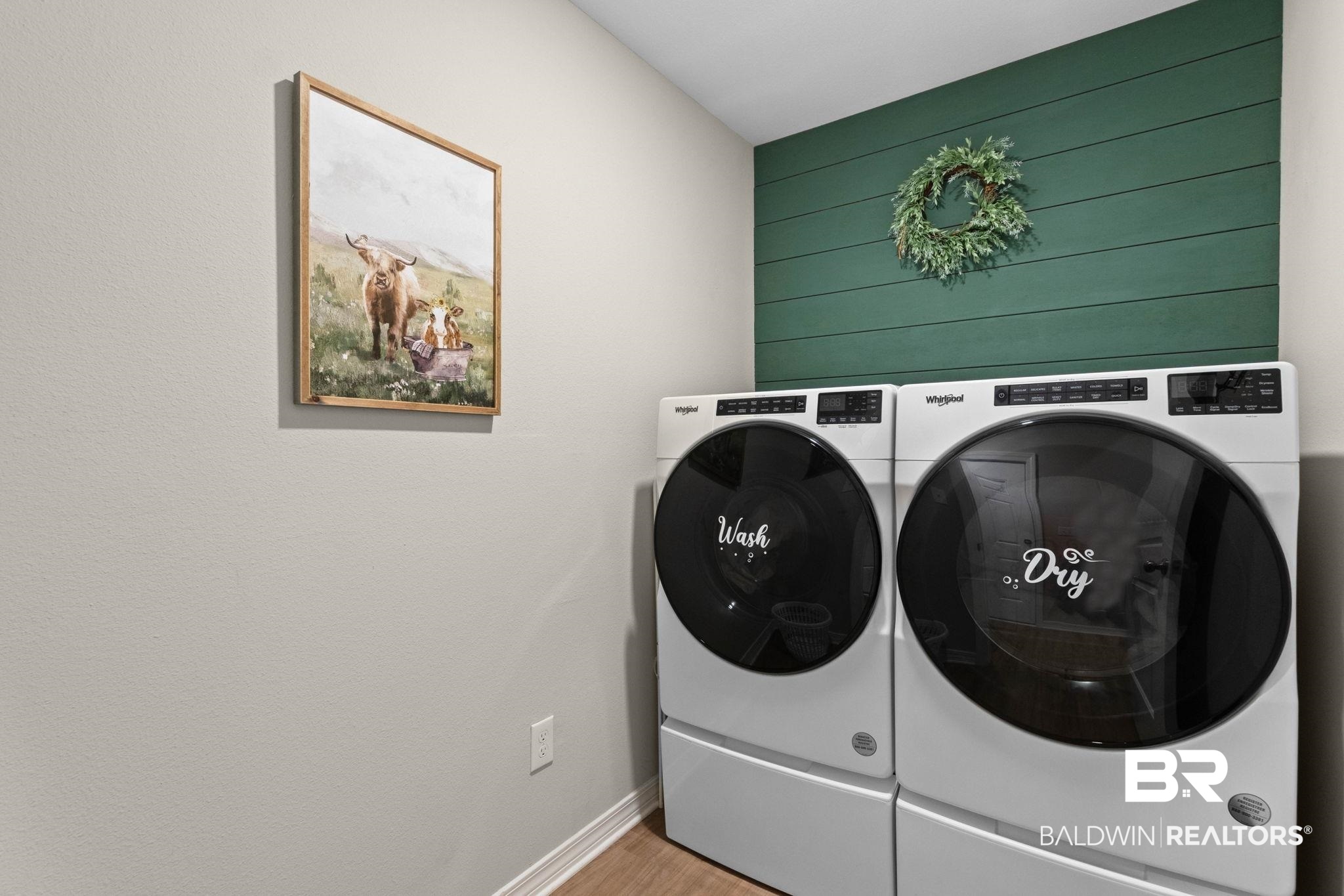 1203 Hayward Loop Foley, AL 36535 - Photo 31 of 41 Laundry room with washer and clothes dryer and light wood-style flooring