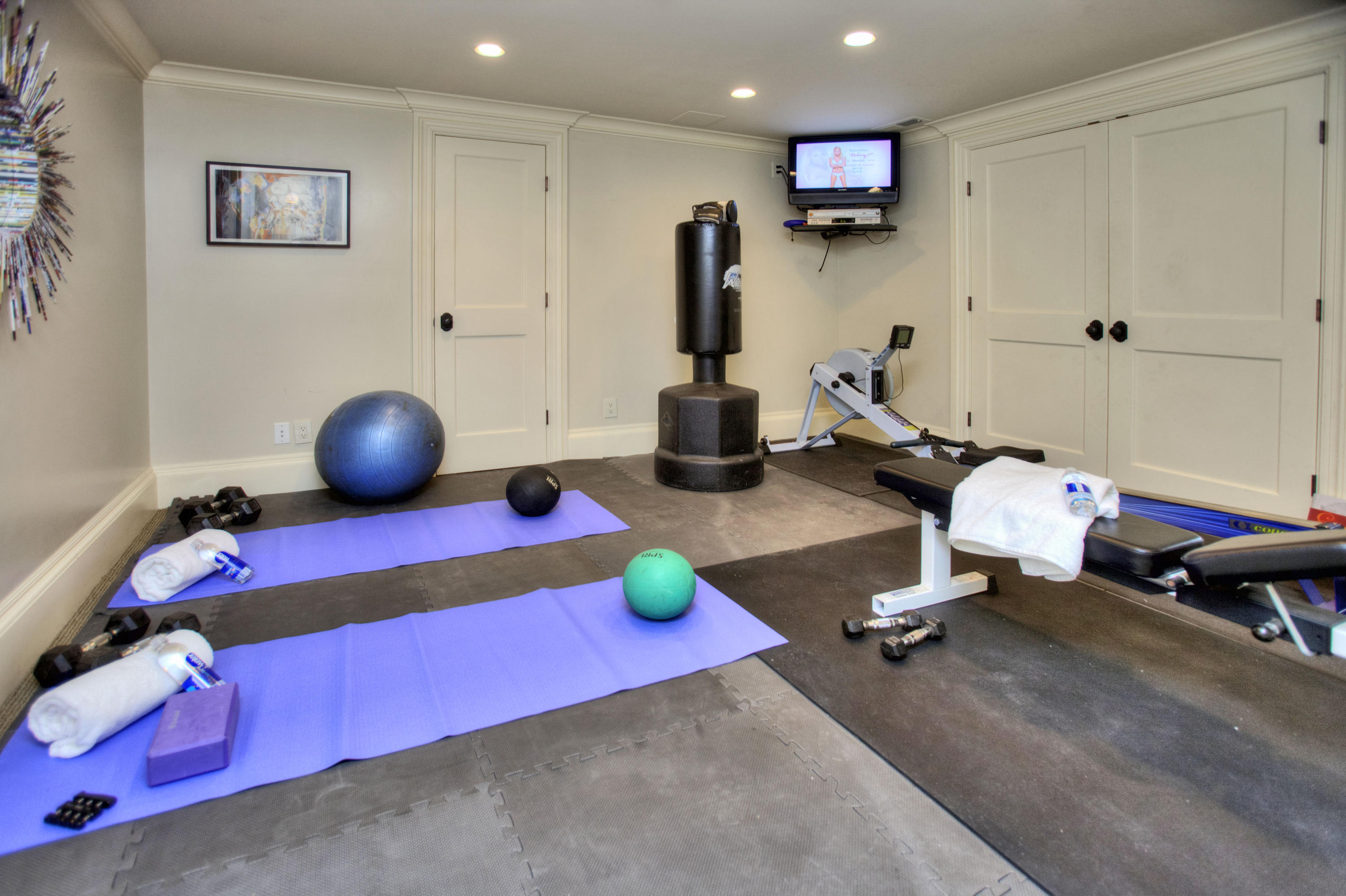 100 Goodwives River Road Darien, CT 06820 - Photo 22 of 25 a room with gym equipment and a flat screen tv
