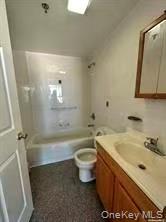 100-05 37th Avenue, Unit 4 Queens, NY 11368 - Photo 9 of 10 Bathroom featuring vanity and shower / tub combination