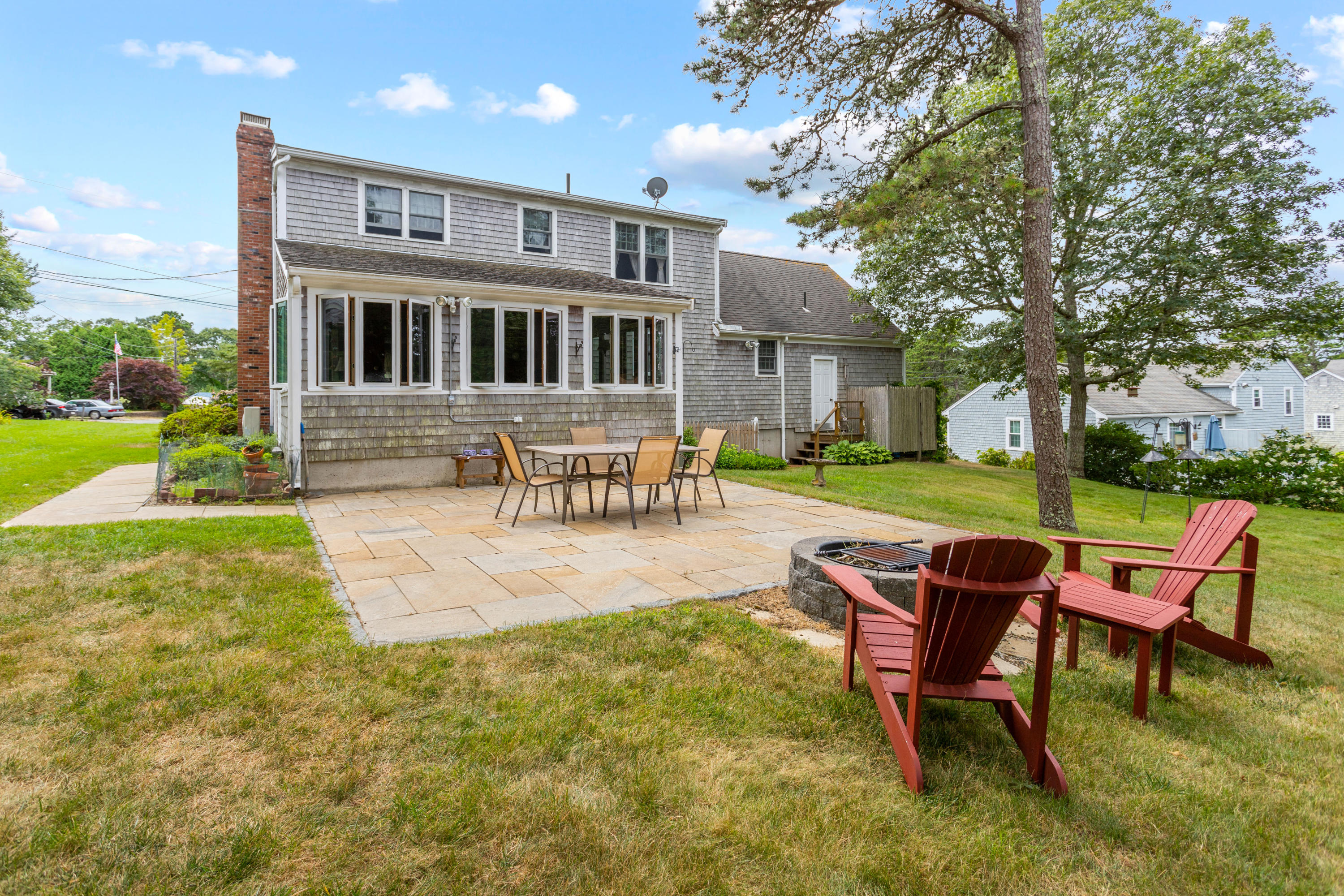 28 Walton Road Harwich, MA 02645 - Photo 4 of 8 a view of a house with backyard porch and sitting area