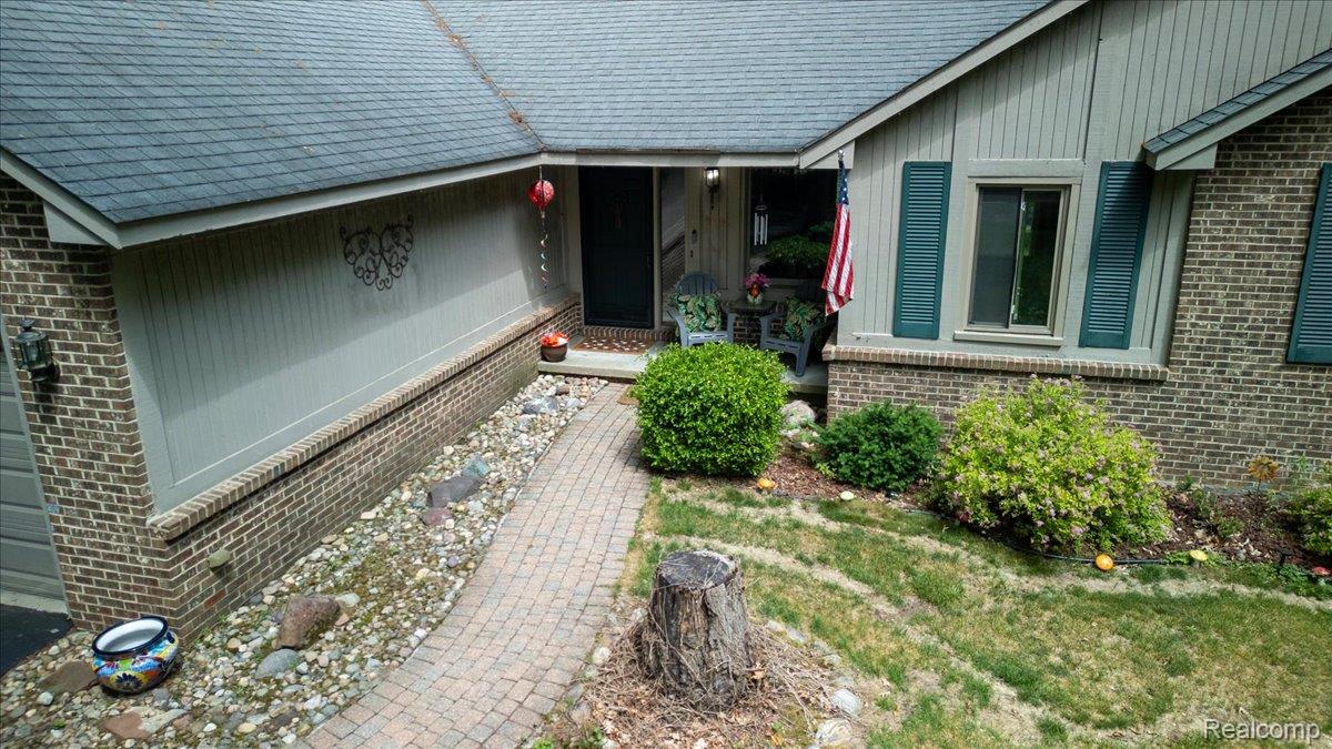 9714 Naiad Road Clarkston, MI 48348 - Photo 15 of 61 Aerial view showcasing the front brick paver walkway that leads to the covered porch and welcoming front entry door.