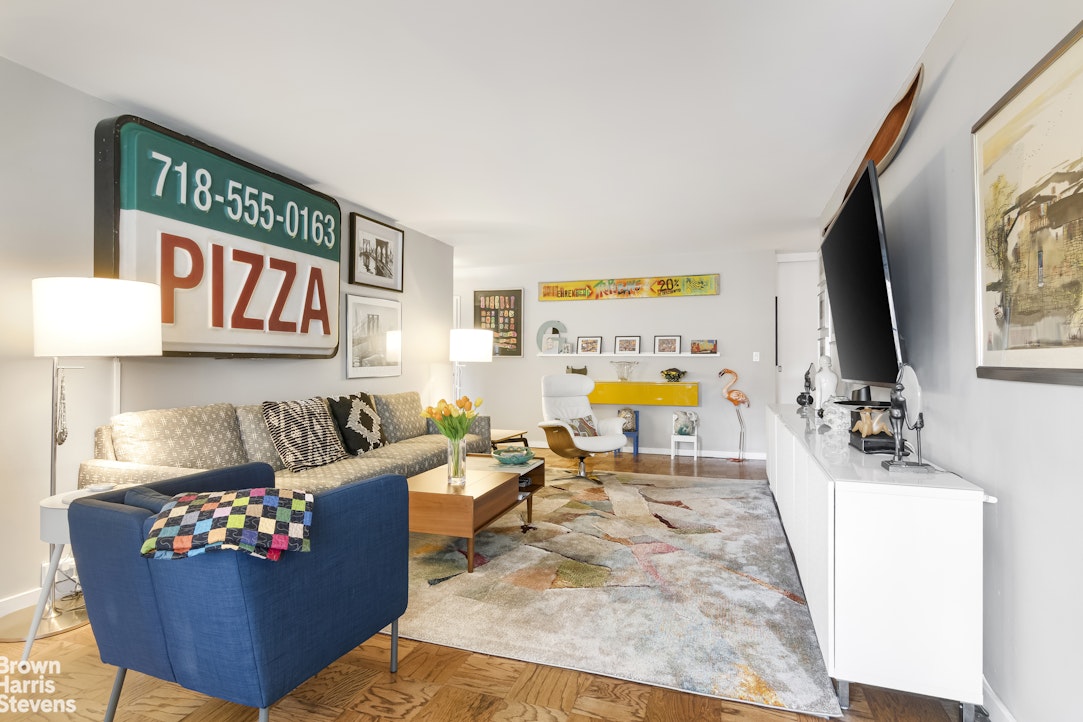 140 West End Avenue, Unit 11B Manhattan, NY 10023 - Photo 1 of 18 a living room with furniture and a flat screen tv