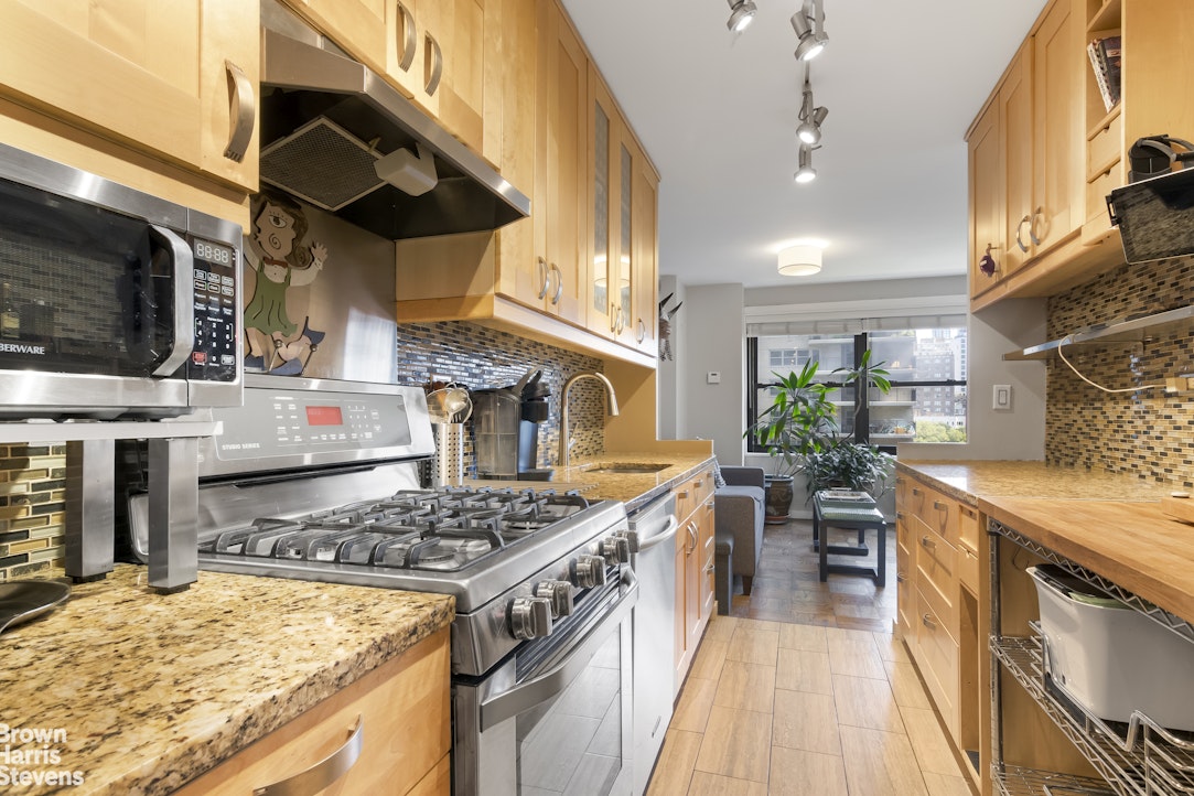 140 West End Avenue, Unit 11B Manhattan, NY 10023 - Photo 5 of 18 a kitchen with a stove and a wooden floors