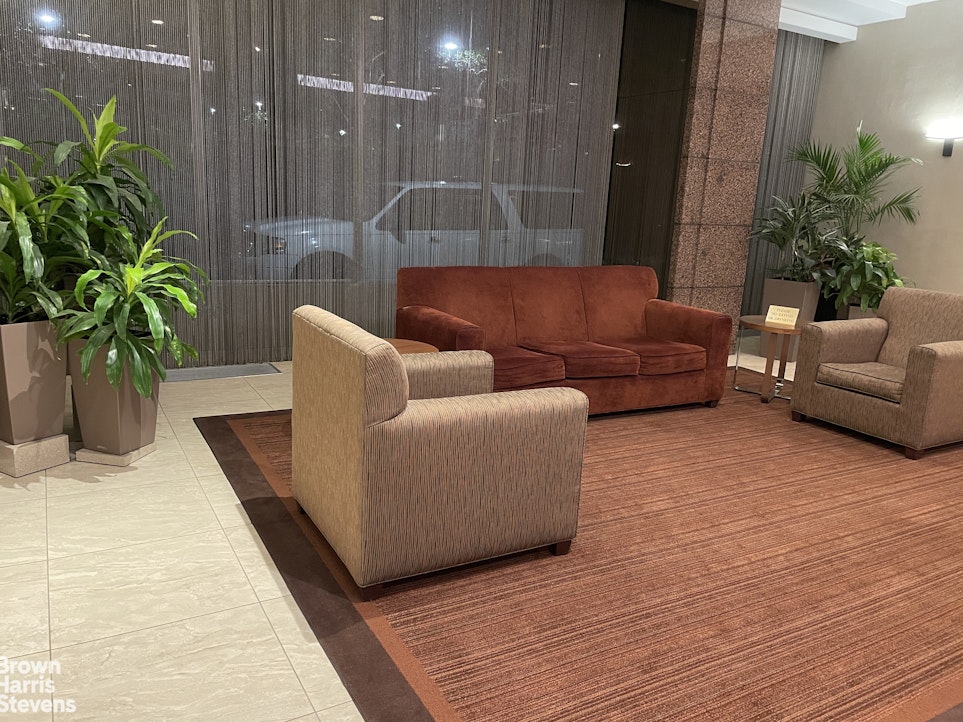 140 West End Avenue, Unit 11B Manhattan, NY 10023 - Photo 9 of 18 a living room with furniture and flowers