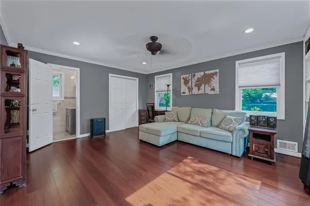 a living room with furniture and wooden floor